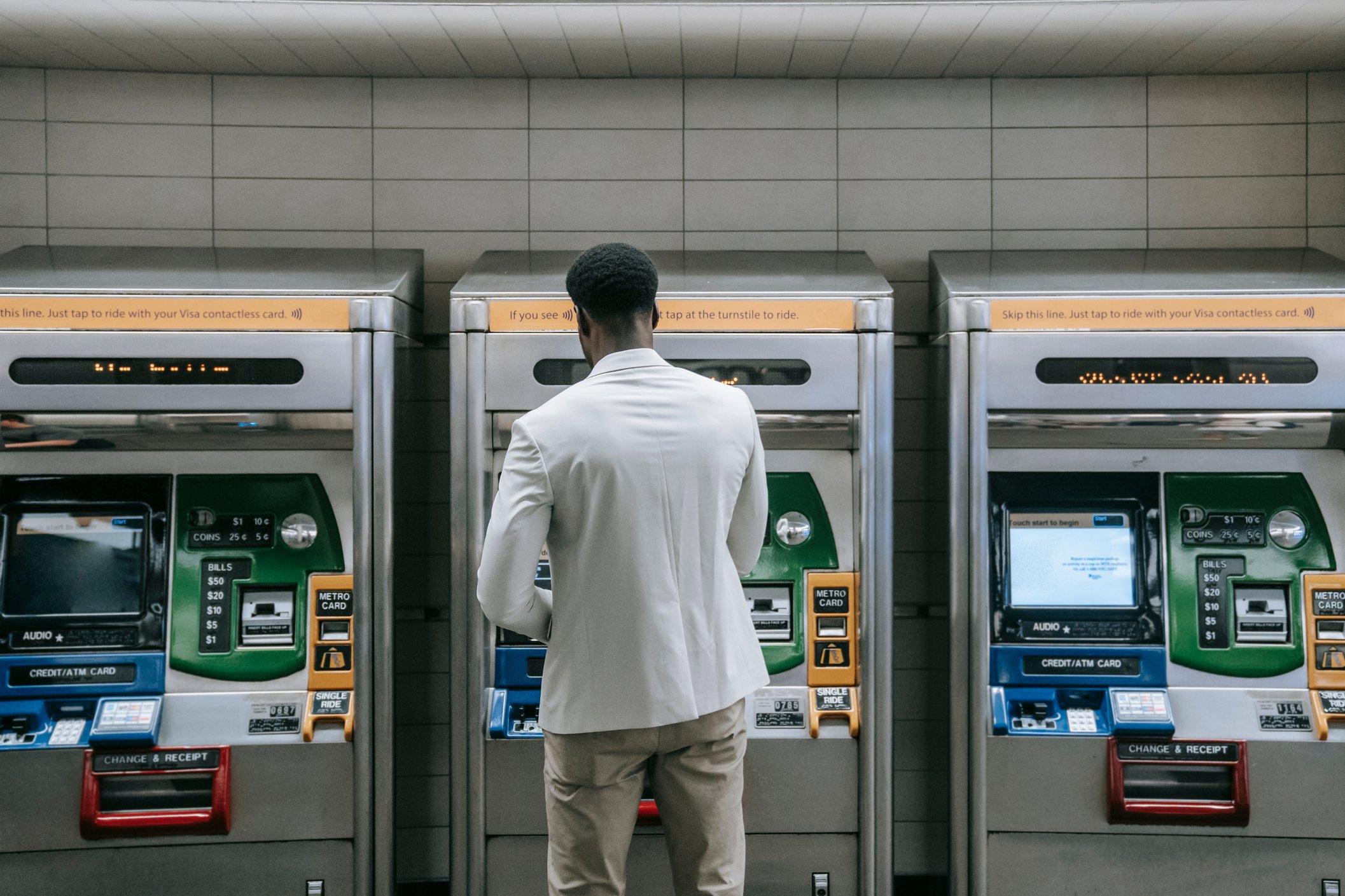 Man Standing in front of a Machine